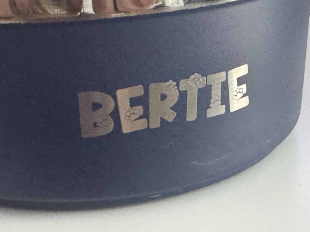 Close-up of a personalised pet bowl engraved in the Vesta workshop