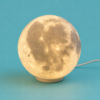 Glowing 3D printed moon lamp on a stand from Vesta Scotland