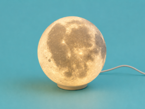 Glowing 3D printed moon lamp on a stand from Vesta Scotland